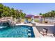 Inviting swimming pool featuring a rock waterfall, spa area, and poolside lounge chairs for a luxurious outdoor experience at 25829 S Mandarin Dr, Queen Creek, AZ 85142