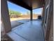 Covered patio opens to a spacious backyard with minimal landscaping and block wall fence at 272 S 228Th Ln, Buckeye, AZ 85326