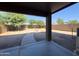 View of the backyard, featuring gravel landscaping, a patio, and block wall fencing for privacy at 272 S 228Th Ln, Buckeye, AZ 85326