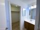 Bright bathroom featuring a single sink vanity and a walk-in closet at 272 S 228Th Ln, Buckeye, AZ 85326