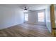 Spacious bedroom with light walls, neutral ceiling fan, and wood-look floors at 272 S 228Th Ln, Buckeye, AZ 85326
