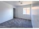 Carpeted bedroom with a large window and walk-in closet at 272 S 228Th Ln, Buckeye, AZ 85326