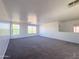 Large carpeted bonus room with several bright windows at 272 S 228Th Ln, Buckeye, AZ 85326