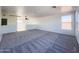 Expansive bonus room with large windows and carpeted flooring at 272 S 228Th Ln, Buckeye, AZ 85326