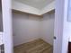 Walk-in closet with wood-style flooring and ample shelving space at 272 S 228Th Ln, Buckeye, AZ 85326