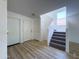 Bright entryway featuring wood-look floors and a staircase leading to the second floor at 272 S 228Th Ln, Buckeye, AZ 85326