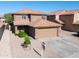 Two-story home featuring a two-car garage, neutral stucco exterior, and tile roof at 272 S 228Th Ln, Buckeye, AZ 85326