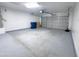 Clean, spacious garage with painted floors and an automatic door at 272 S 228Th Ln, Buckeye, AZ 85326