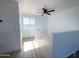 Bright hallway with wood-look floors, a window, and a ceiling fan at 272 S 228Th Ln, Buckeye, AZ 85326