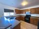 Efficient kitchen features stainless steel sink and black appliances at 272 S 228Th Ln, Buckeye, AZ 85326
