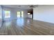 Bright, open living room featuring wood-look floors and access to the kitchen at 272 S 228Th Ln, Buckeye, AZ 85326