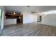 Open-concept living room with light walls, modern ceiling fan, and wood-look floors at 272 S 228Th Ln, Buckeye, AZ 85326