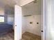 Bright storage room with shelving, power outlets, and wood-style floors at 272 S 228Th Ln, Buckeye, AZ 85326