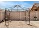 Backyard view with a decorative pergola under construction in a gravel landscape, ready for summer relaxation and outdoor enjoyment at 2723 W Apollo Rd, Phoenix, AZ 85041
