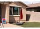 Picturesque backyard featuring lush artificial turf, a modern window, and stylish patio umbrella for outdoor relaxation and entertainment at 2723 W Apollo Rd, Phoenix, AZ 85041