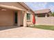 Spacious covered patio next to artificial turf, completed with a dog in the shade and view of a well-maintained backyard at 2723 W Apollo Rd, Phoenix, AZ 85041