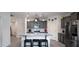 Elegant kitchen with a granite island, stainless steel appliances, pendant lights, and ample cabinet space at 2723 W Apollo Rd, Phoenix, AZ 85041
