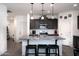 Stylish kitchen with a large island, granite countertops, stainless steel appliances, and modern pendant lighting at 2723 W Apollo Rd, Phoenix, AZ 85041