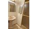 Bathroom featuring a pedestal sink and a glass-enclosed shower at 2937 E Garnet Cir, Mesa, AZ 85204
