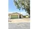 Single-story home with a two-car garage, front yard, and mature shade tree at 2937 E Garnet Cir, Mesa, AZ 85204