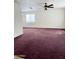 Spacious living room with a ceiling fan, natural light, and neutral-toned walls at 2937 E Garnet Cir, Mesa, AZ 85204