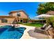 Expansive backyard featuring a pool, lush lawn, and an outdoor dining area at 3581 W Ironwood Dr, Chandler, AZ 85226