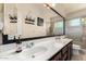 Bathroom with dual sinks, a large mirror, and a glass enclosed shower at 3581 W Ironwood Dr, Chandler, AZ 85226