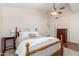 Comfortable bedroom with wood floors, a ceiling fan, and light colored walls at 3581 W Ironwood Dr, Chandler, AZ 85226