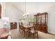Formal dining room featuring a dark wood table, china cabinet, and plantation shutters at 3581 W Ironwood Dr, Chandler, AZ 85226