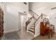 Bright foyer with a staircase, neutral tile flooring, and a decorative piano at 3581 W Ironwood Dr, Chandler, AZ 85226