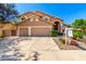 Charming tan home with a three-car garage, arched entry, and professionally landscaped front yard at 3581 W Ironwood Dr, Chandler, AZ 85226