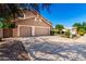 Charming tan home with a three-car garage, long driveway, and professionally landscaped front yard at 3581 W Ironwood Dr, Chandler, AZ 85226