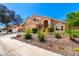 Charming tan home with a three-car garage and professionally landscaped front yard at 3581 W Ironwood Dr, Chandler, AZ 85226