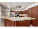 Well-lit kitchen featuring wood cabinets, granite countertops, and stainless steel appliances at 3581 W Ironwood Dr, Chandler, AZ 85226
