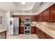 Stylish kitchen showcases stainless steel appliances, granite countertops, and wood cabinets at 3581 W Ironwood Dr, Chandler, AZ 85226