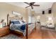 Spacious main bedroom with hardwood floors, ceiling fan, and en-suite bathroom at 3581 W Ironwood Dr, Chandler, AZ 85226