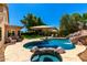 Backyard oasis showcasing a private pool, spa, and a meticulously manicured lawn at 3581 W Ironwood Dr, Chandler, AZ 85226
