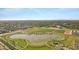 Aerial view displaying community's serene lake, green recreational areas, and well-maintained landscapes under a clear sky at 3929 E Bloomfield Pkwy, Gilbert, AZ 85296