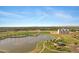 Scenic aerial view highlighting the community lake with fountain, green fields, and community recreational facilities at 3929 E Bloomfield Pkwy, Gilbert, AZ 85296