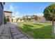 Large backyard with pavers, decorative trees, a grass lawn and a hammock at 3929 E Bloomfield Pkwy, Gilbert, AZ 85296