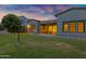 This landscaped backyard features a well-maintained lawn, covered patio, and modern home design at 3929 E Bloomfield Pkwy, Gilbert, AZ 85296