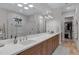 Bathroom with double vanity, large mirror and glass enclosed shower with tile at 3929 E Bloomfield Pkwy, Gilbert, AZ 85296