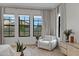 Bedroom chair next to bright windows with view of lawn and modern drapes at 3929 E Bloomfield Pkwy, Gilbert, AZ 85296