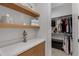 Well-organized closet with wooden shelves and cabinets providing ample storage space at 3929 E Bloomfield Pkwy, Gilbert, AZ 85296