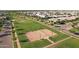 Aerial view of neighborhood park with sand volleyball court surrounded by lush green lawns and neighborhood homes at 3929 E Bloomfield Pkwy, Gilbert, AZ 85296