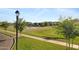 Neighborhood park featuring a basketball court with surrounding lawns, trees, and walkways at 3929 E Bloomfield Pkwy, Gilbert, AZ 85296