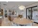 Open dining and kitchen area featuring modern lighting, stainless steel appliances and backyard access at 3929 E Bloomfield Pkwy, Gilbert, AZ 85296