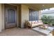 Elegant front entry with wrought iron door and comfortable patio furniture at 3929 E Bloomfield Pkwy, Gilbert, AZ 85296