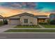 Charming single-story home with manicured lawn and desert landscaping at sunset at 3929 E Bloomfield Pkwy, Gilbert, AZ 85296