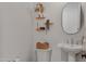 Cozy half bathroom featuring a stylish sink, mirror, and decorative shelves, adding a touch of elegance at 3929 E Bloomfield Pkwy, Gilbert, AZ 85296